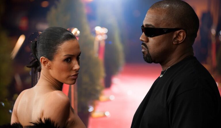 Bianca and Kanye standing in front of red carpet background